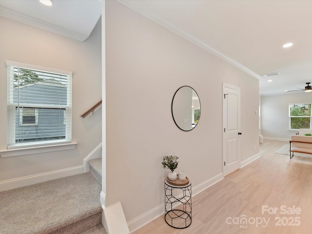 hallway featuring stairway, baseboards, light wood finished floors, ornamental molding, and recessed lighting