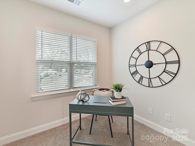 carpeted office space with baseboards and visible vents