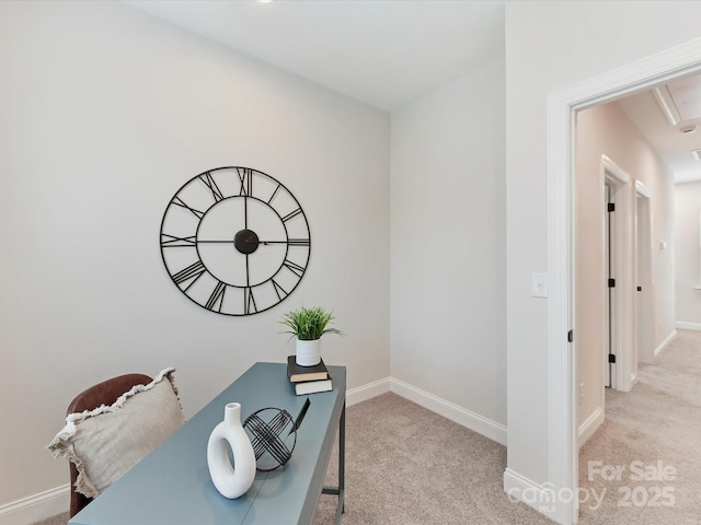 carpeted office space with baseboards and attic access