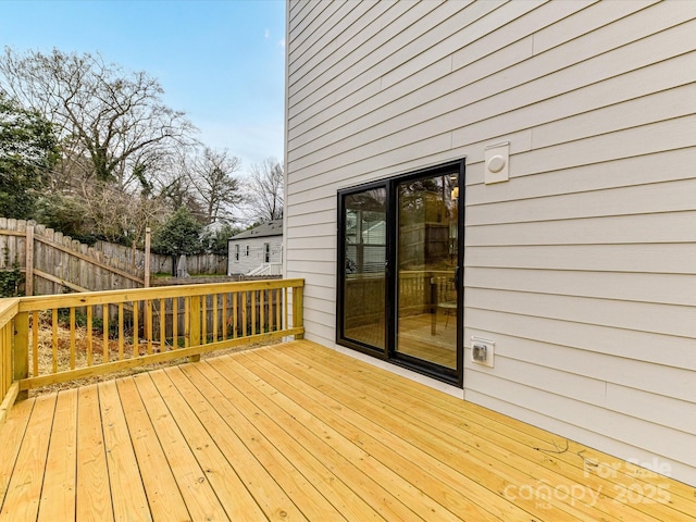 wooden terrace featuring fence