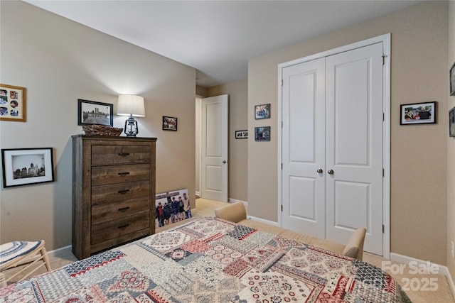 bedroom with a closet and baseboards