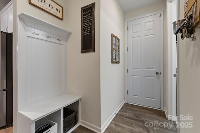 mudroom with baseboards and dark wood-style flooring