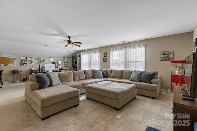 living room with lofted ceiling, baseboards, visible vents, and light colored carpet