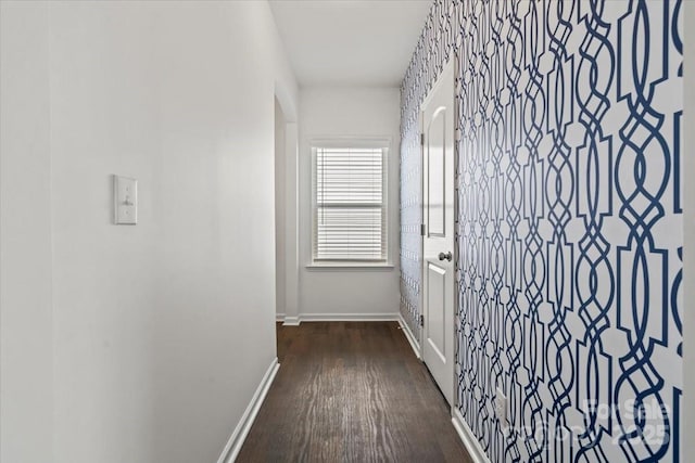 hallway with dark wood-style floors and baseboards