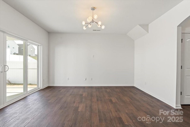 empty room featuring dark wood-type flooring, visible vents, baseboards, and an inviting chandelier