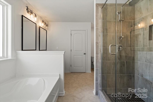 full bath featuring a garden tub, a shower stall, toilet, and baseboards