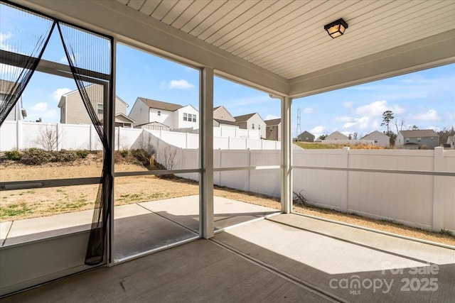 unfurnished sunroom featuring a residential view