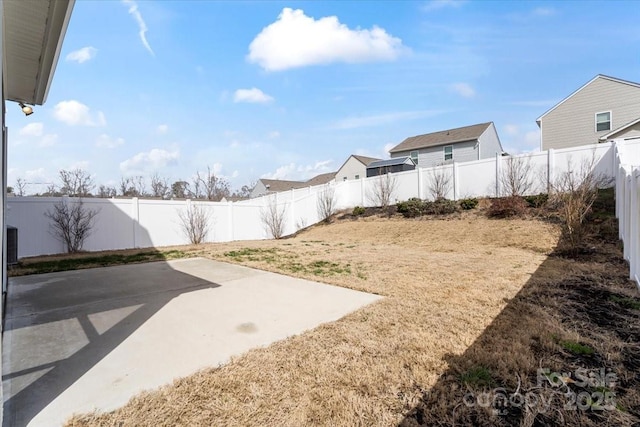 view of yard with a patio area and a fenced backyard