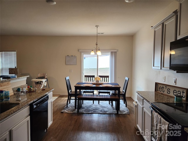 dining space featuring dark wood-style floors and baseboards