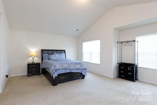 carpeted bedroom with lofted ceiling, visible vents, and baseboards