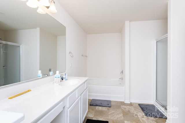 full bath featuring a stall shower, a garden tub, and vanity