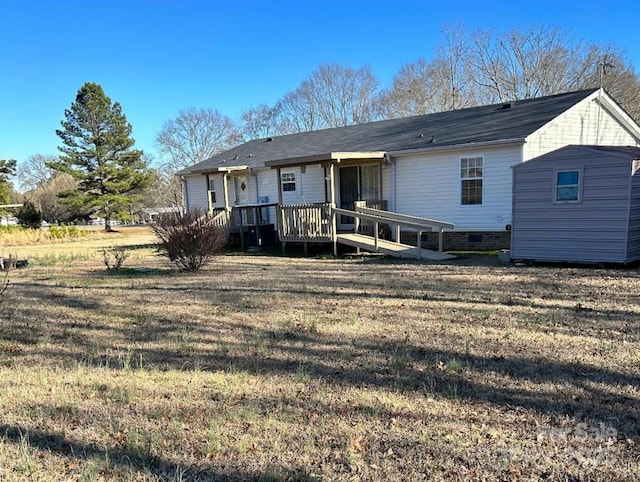 rear view of house with a yard, crawl space, and a wooden deck