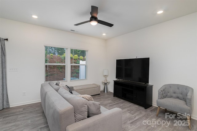 living room featuring visible vents, baseboards, a ceiling fan, wood finished floors, and recessed lighting