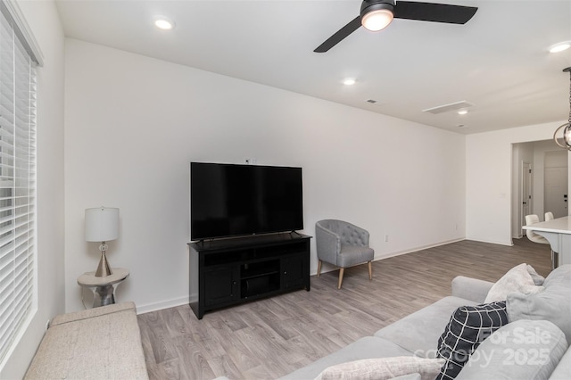 living room featuring a ceiling fan, recessed lighting, baseboards, and wood finished floors