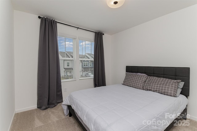 bedroom featuring carpet and baseboards