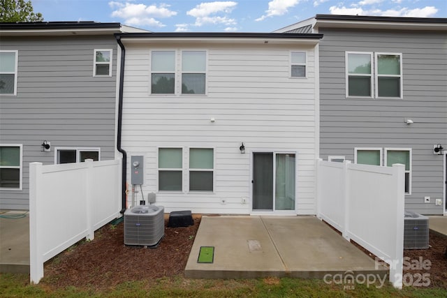 rear view of house with a patio area, fence, and central AC unit