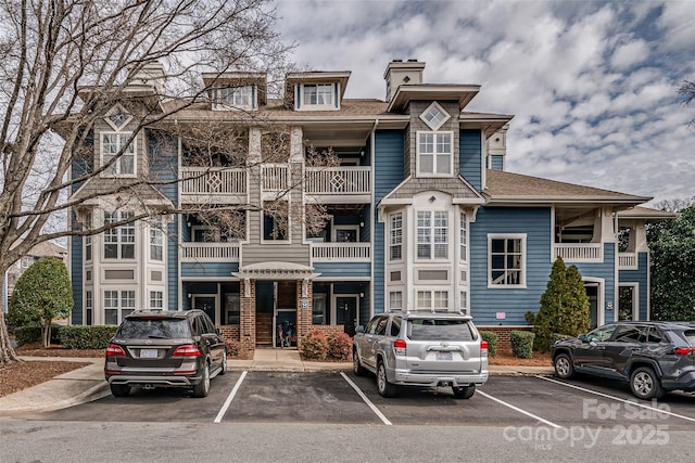 view of building exterior featuring uncovered parking