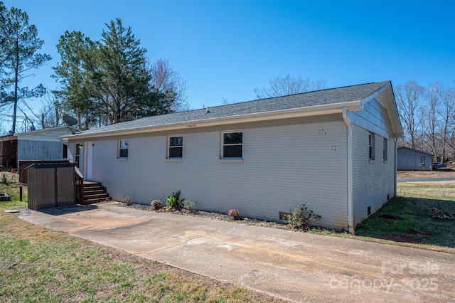 back of house with crawl space and brick siding