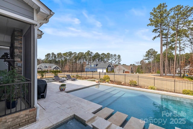 view of pool with a fenced backyard and a patio area