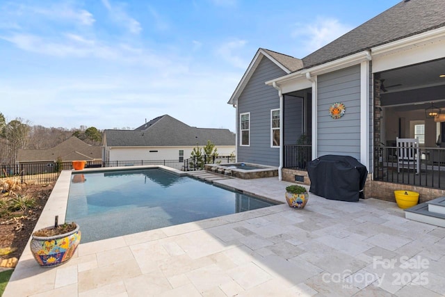 view of swimming pool featuring a fenced in pool, a fenced backyard, a patio area, a grill, and an in ground hot tub