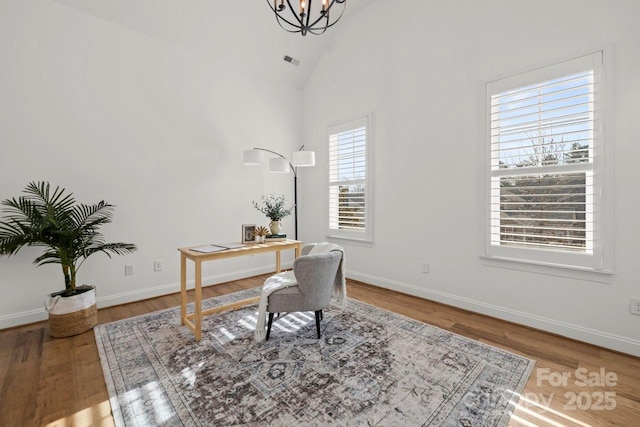 office space with visible vents, baseboards, a chandelier, and vaulted ceiling