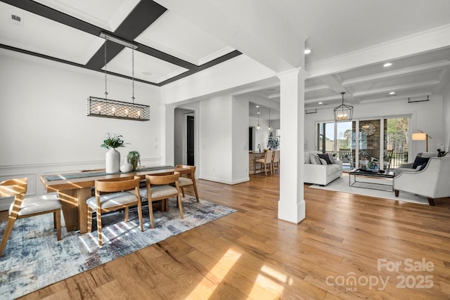 dining area featuring light wood-type flooring, coffered ceiling, beamed ceiling, and ornate columns