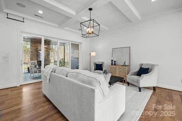 living room featuring wood finished floors, baseboards, coffered ceiling, crown molding, and a chandelier