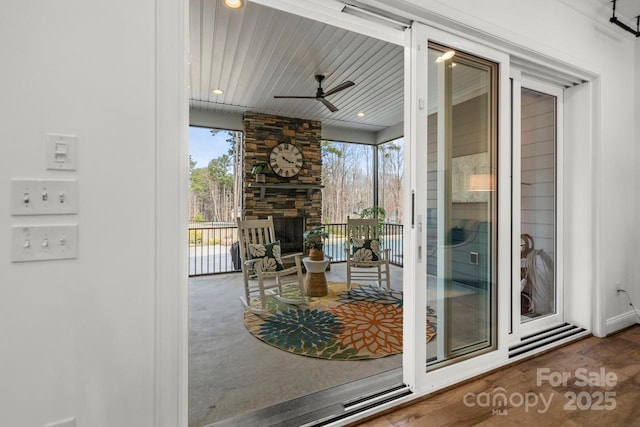 interior space with a fireplace and a ceiling fan