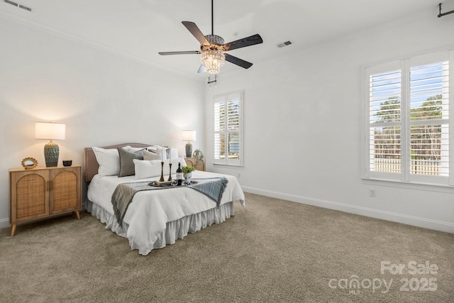 carpeted bedroom with visible vents, ceiling fan, baseboards, and ornamental molding