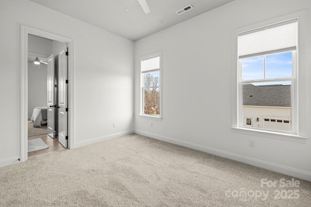 unfurnished bedroom featuring visible vents, ceiling fan, baseboards, and carpet