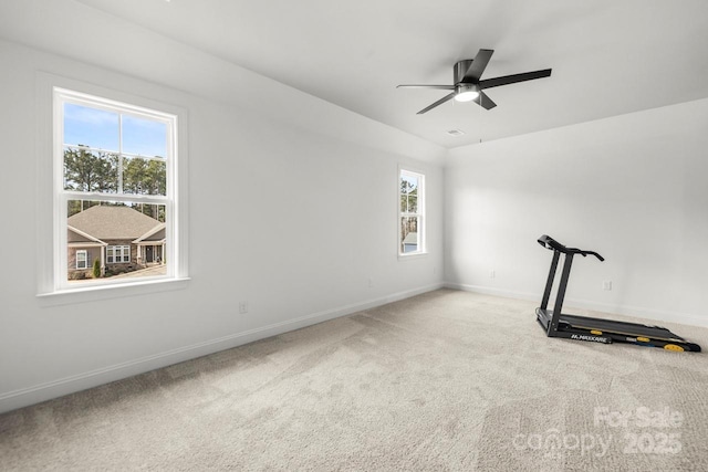 interior space featuring baseboards, carpet floors, and ceiling fan