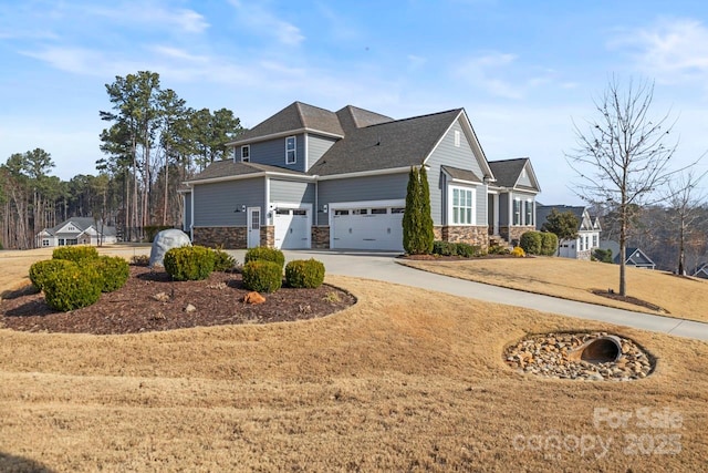 view of front of house featuring concrete driveway, an attached garage, and stone siding