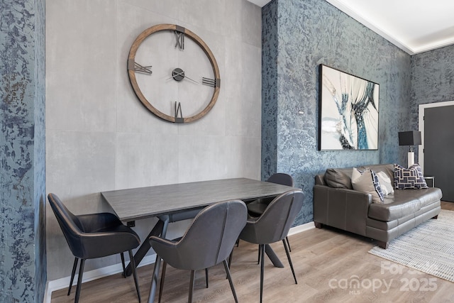 dining area with wood finished floors and baseboards