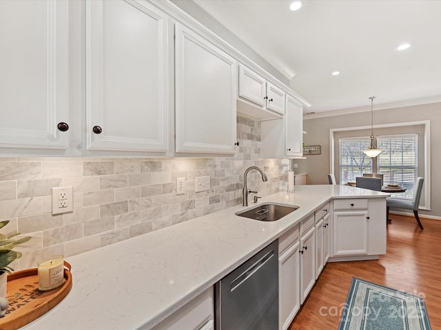 kitchen featuring a sink, white cabinets, ornamental molding, dishwasher, and tasteful backsplash