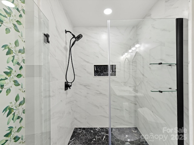 bathroom with a marble finish shower