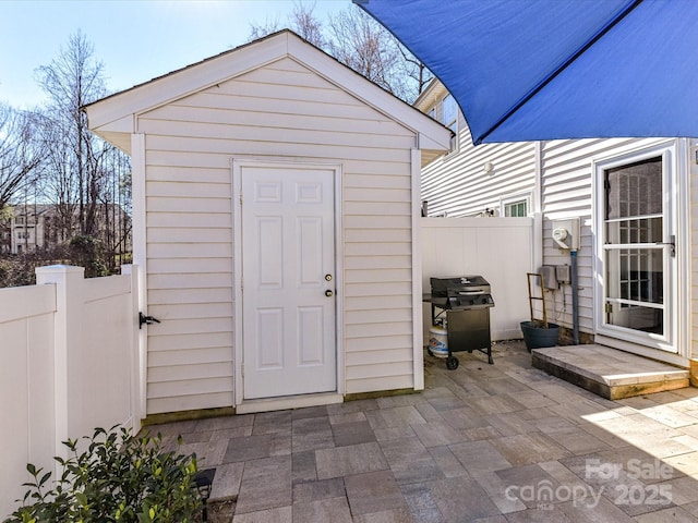 view of shed with fence