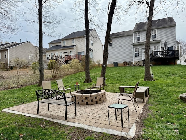 view of home's community with a lawn, a deck, a patio, a residential view, and a fire pit