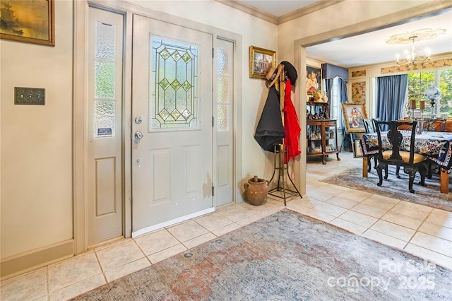 tiled foyer featuring crown molding and an inviting chandelier