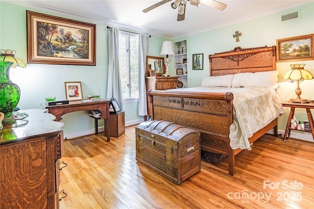 bedroom with visible vents, ornamental molding, ceiling fan, light wood-type flooring, and baseboards