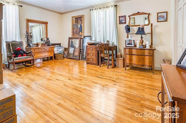 office space with light wood-type flooring and crown molding