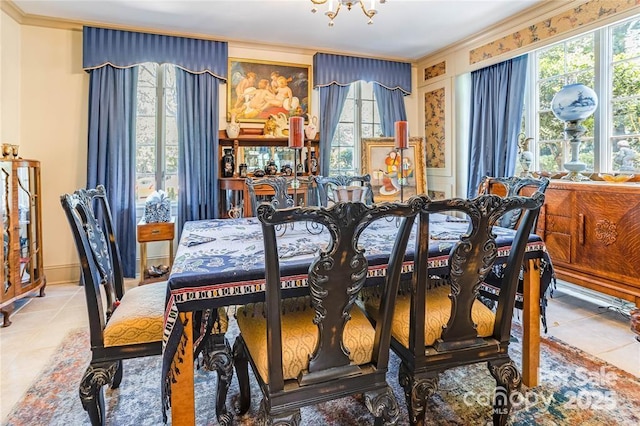 dining area with an inviting chandelier, crown molding, and tile patterned floors