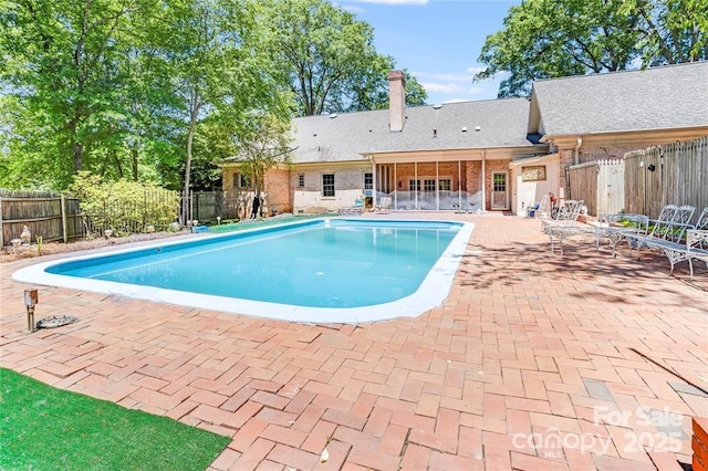 view of swimming pool with a fenced backyard, a fenced in pool, and a patio