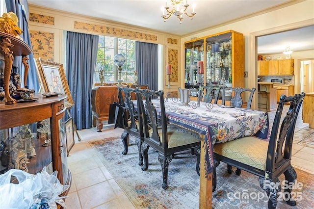 dining area with light tile patterned floors, crown molding, and a notable chandelier