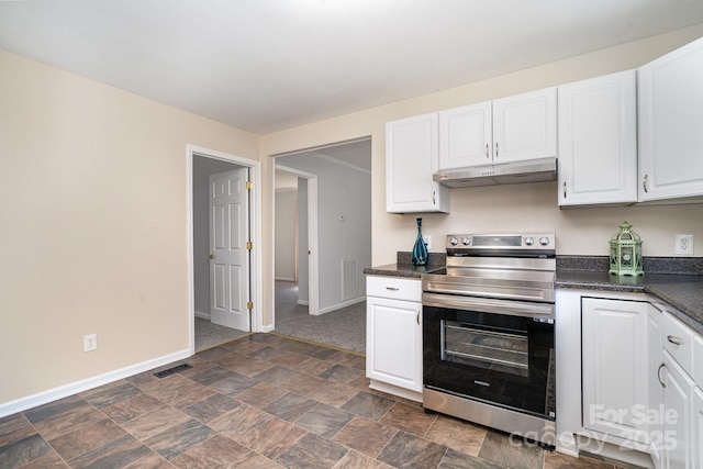 kitchen featuring under cabinet range hood, stainless steel electric stove, white cabinetry, and dark countertops