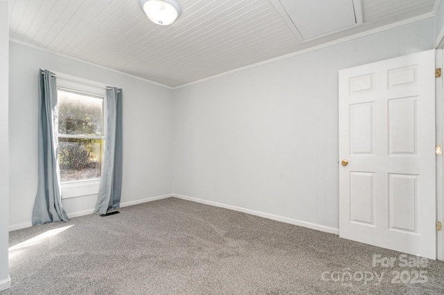 carpeted empty room featuring baseboards and ornamental molding