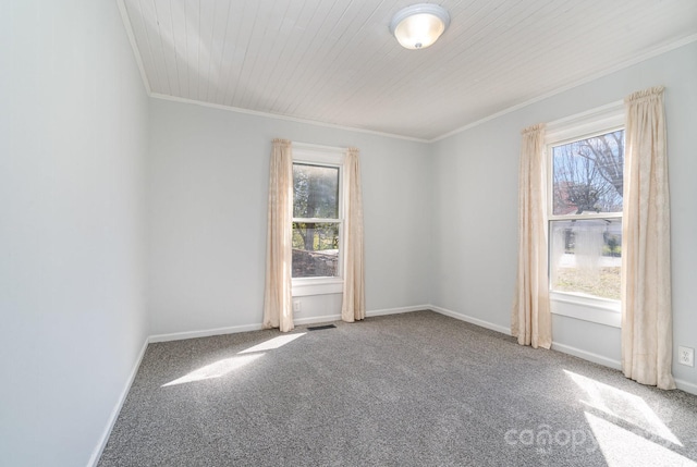 unfurnished room featuring a wealth of natural light, visible vents, crown molding, and baseboards
