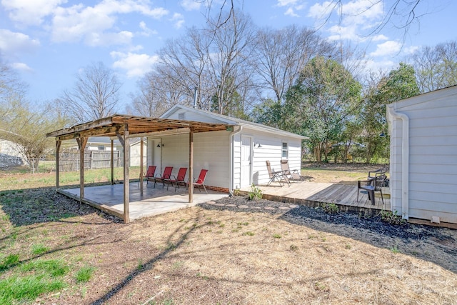 view of yard with a wooden deck and a patio