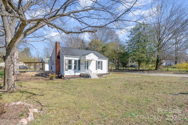 bungalow-style house featuring a front lawn and a chimney