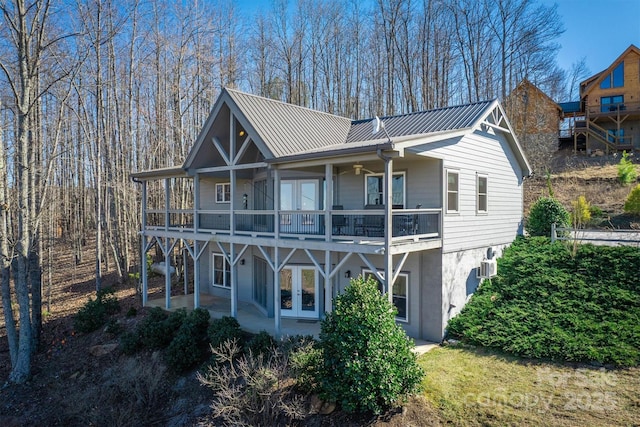 rear view of property with metal roof, a patio, and french doors