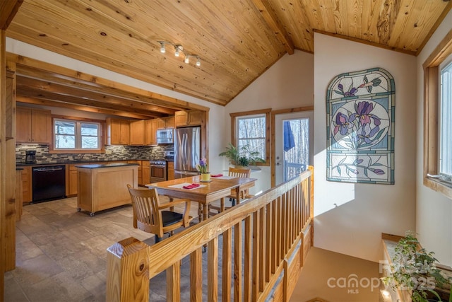 dining room with vaulted ceiling with beams and wood ceiling